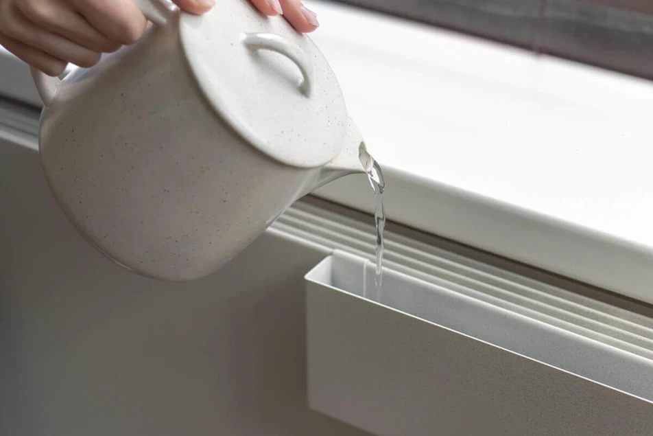 Radiator cover with water tray
